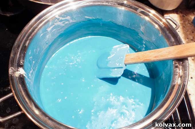 Coloring the marshmallow mixture for the Elsa Rice Krispie Treats