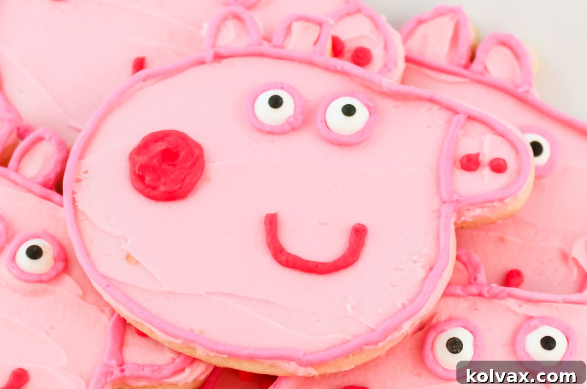 Close-up of vibrant pink Peppa Pig sugar cookies, perfectly frosted and decorated, stacked on a white plate, ready for a themed party.