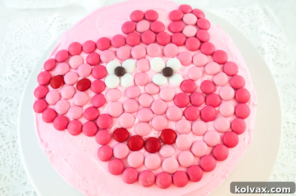 Closeup on a top view of an Easy Peppa Pig Birthday Party Cake sitting on a white cake plate on a white table.