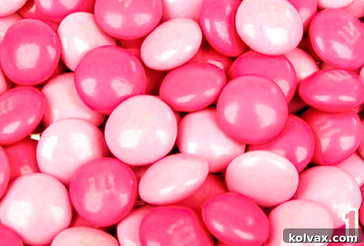 Closeup on a large pile of Dark and Light Pink M&M's.