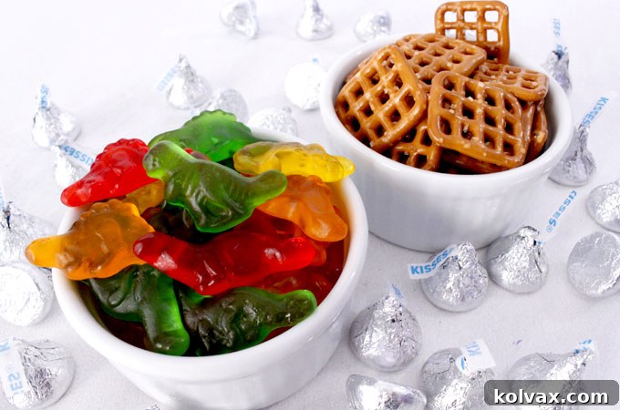 Gathering Ingredients: Pretzel Snaps, Hershey's Kisses, and Gummy Dinosaurs for Easy Treats