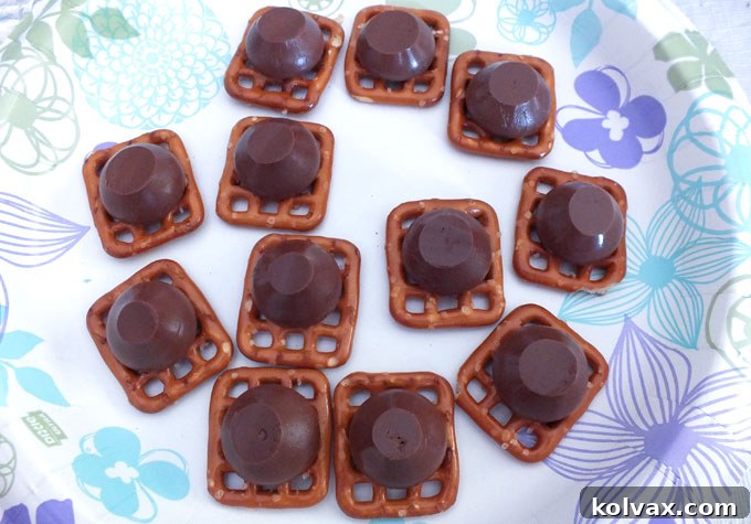 Melting Hershey's Kisses on Pretzel Snaps: The First Step to Sweet Dinosaur Treats