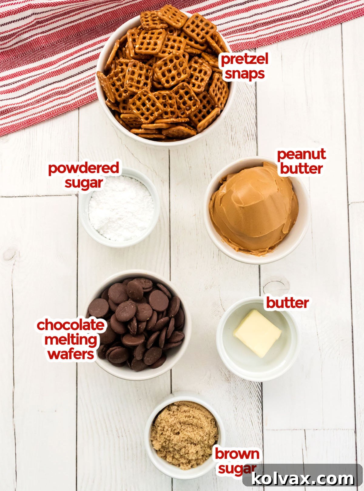 All the ingredients you will need to make Chocolate Peanut Butter Pretzel Bites including Pretzel Snaps, Powdered Sugar, Peanut Butter, Chocolate Melting Wafers, Butter and Brown Sugar laid out on a white surface.