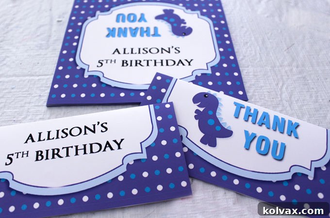 Printed thank-you labels for dinosaur cookies, trimmed and folded in half, ready for attachment.