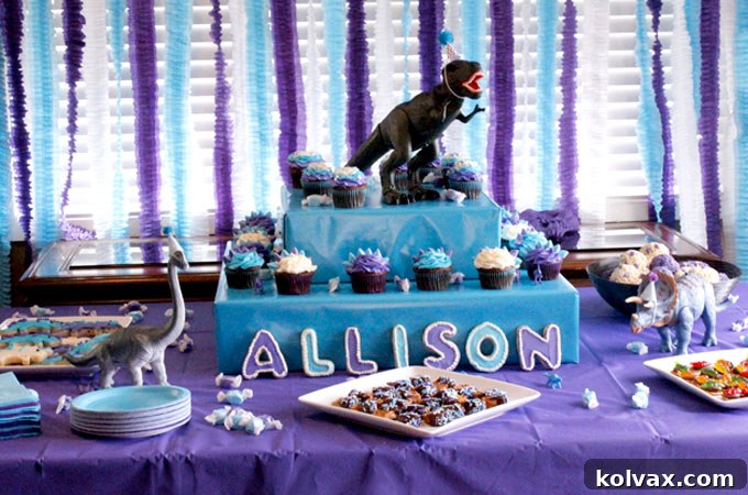 Make Stunning Ruffled Streamers 9 Dinosaur Party dessert table adorned with colorful ruffled streamers as a vibrant backdrop, showcasing how DIY decorations enhance the party theme and excitement.