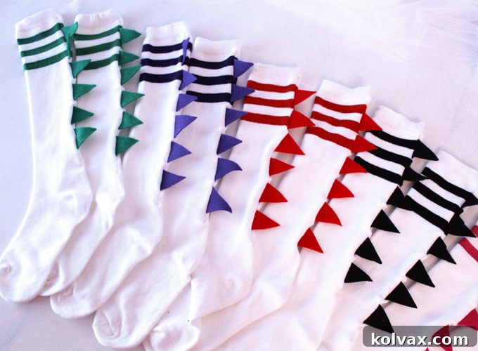 A completed pair of DIY Dinosaur Socks, showcasing the vibrant felt spikes and the ease of this fun party favor craft.