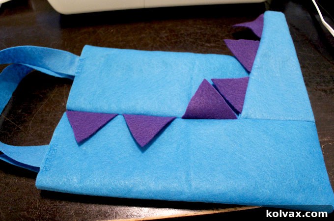 Instructions for sewing the front and back panels of the dinosaur party favor bag together, including tips for handling minor size differences and trimming excess felt.