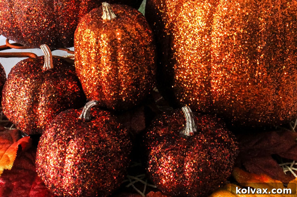 Glamorous Glitter Pumpkin Decor 2 Closeup on an arrangement of Orange DIY Glitter Pumpkins in a variety of sizes, showcasing their vibrant sparkle.