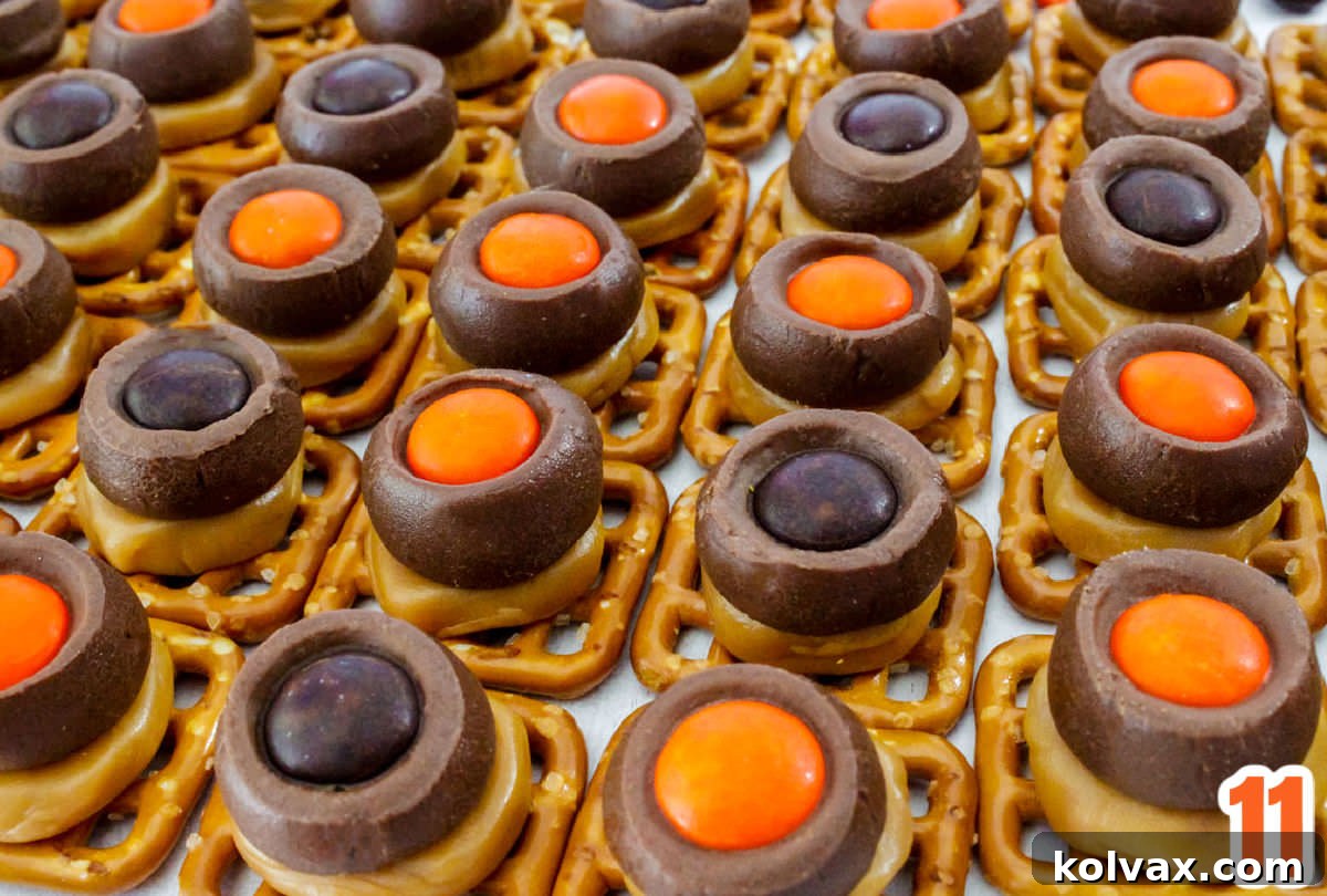 Spooky Salty Sweet Pretzel Delights 6 Rows of perfectly assembled Halloween Chocolate Caramel Pretzel Bites displayed neatly on a clean white table, showcasing their uniform and inviting appearance.