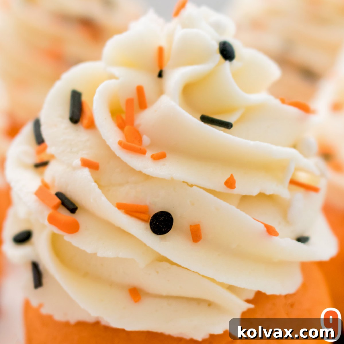 Closeup of a beautifully frosted Brownie Cupcake with a perfect buttercream swirl, generously covered in festive Halloween sprinkles.