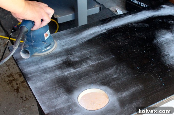 Lightly sanding the Ikea Sundvik Table for paint adhesion