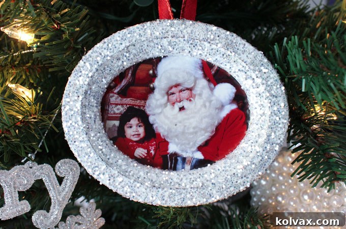 Shimmering Photo Keepsake Ornaments 2 These DIY Glitter Photo Christmas Tree Ornaments are beautiful and easy to make. These handmade sparkling picture frame ornaments will display your favorite family holiday memories right there on your Christmas Tree for all the years to come. Pin this fun Christmas Craft for later and follow us for more great Christmas Decoration ideas and crafts.