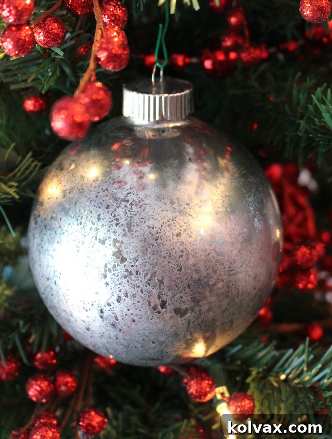 Finished DIY Mercury Glass Ornaments hanging elegantly on a Christmas tree