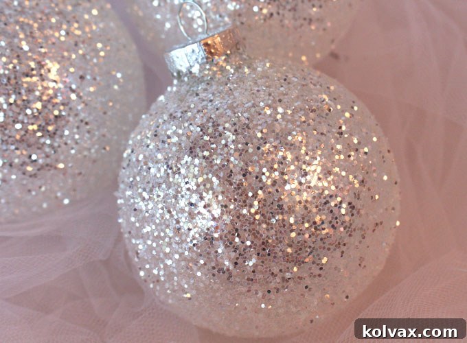 Beautiful DIY White and Silver Glitter Christmas Ornaments, handmade and sparkling, ready for display.