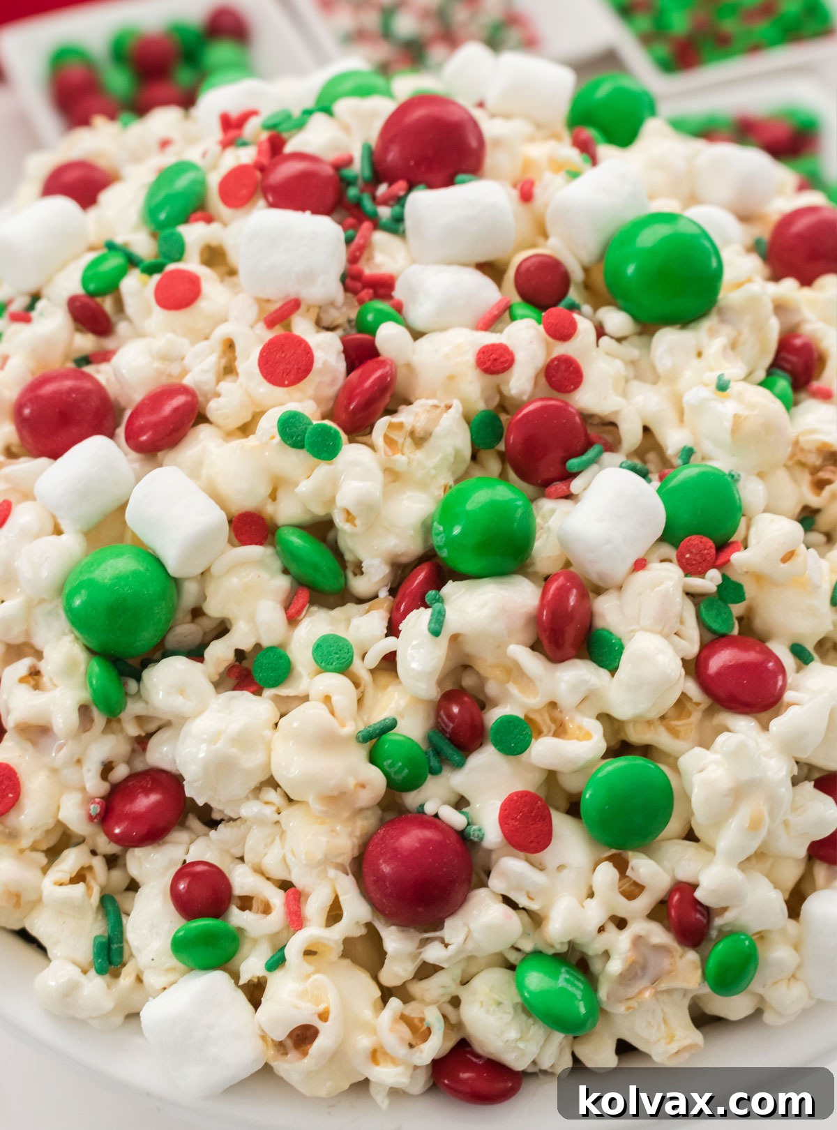 Closeup on a white serving bowl filled with Santa Crunch Popcorn.