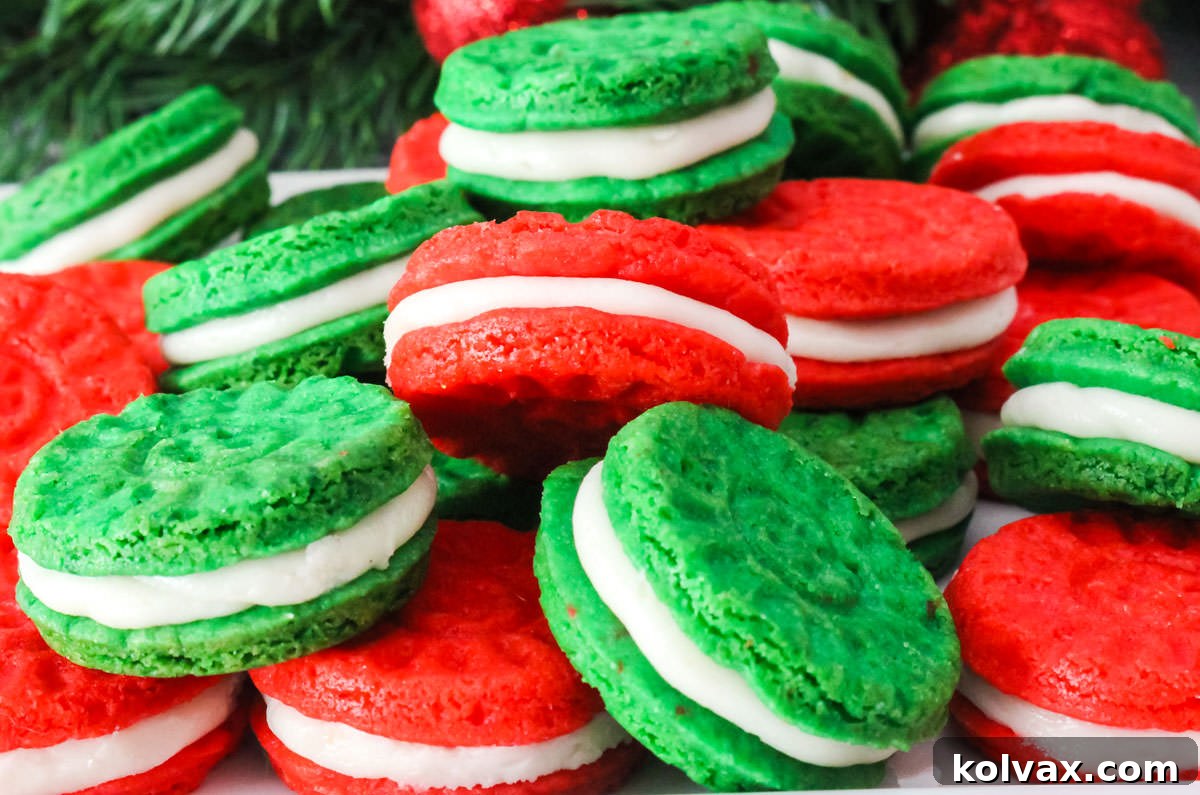 Closeup on a pile of Red and Green Christmas Sugar Cookie Sandwiches sitting on a white serving platter, ready to be enjoyed during the holiday season.