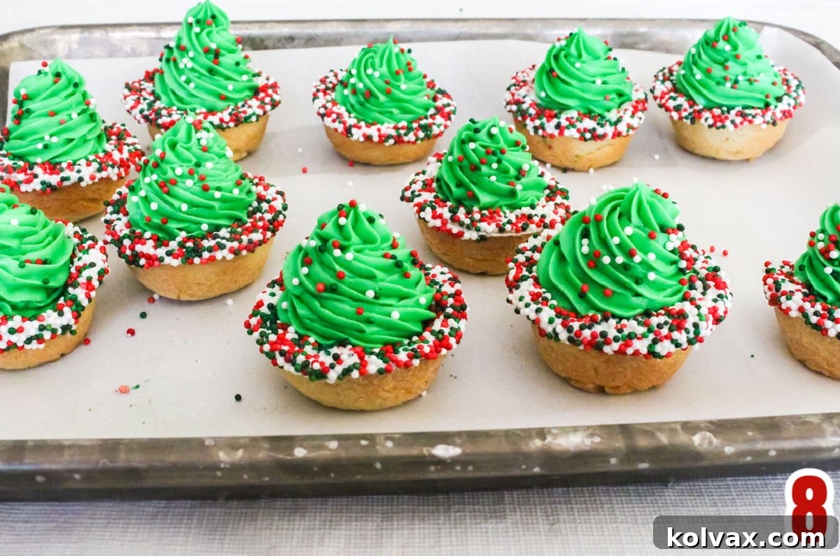 A cookie sheet filled with Christmas Tree Cookie Cups.