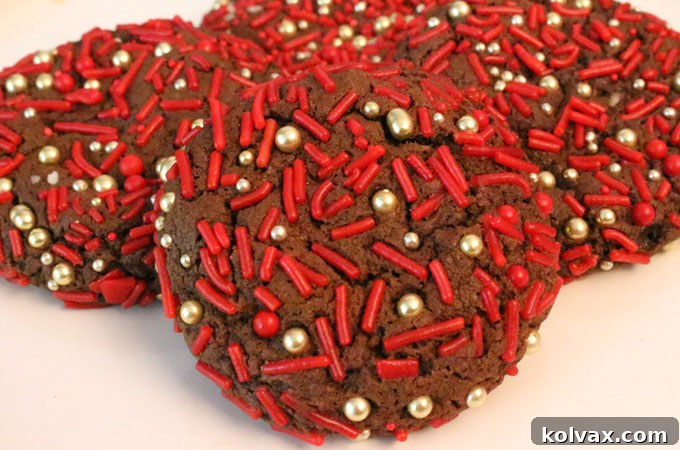 Freshly baked and beautifully cracked Christmas Sprinkles Chocolate Cookies cooling on a wire rack.