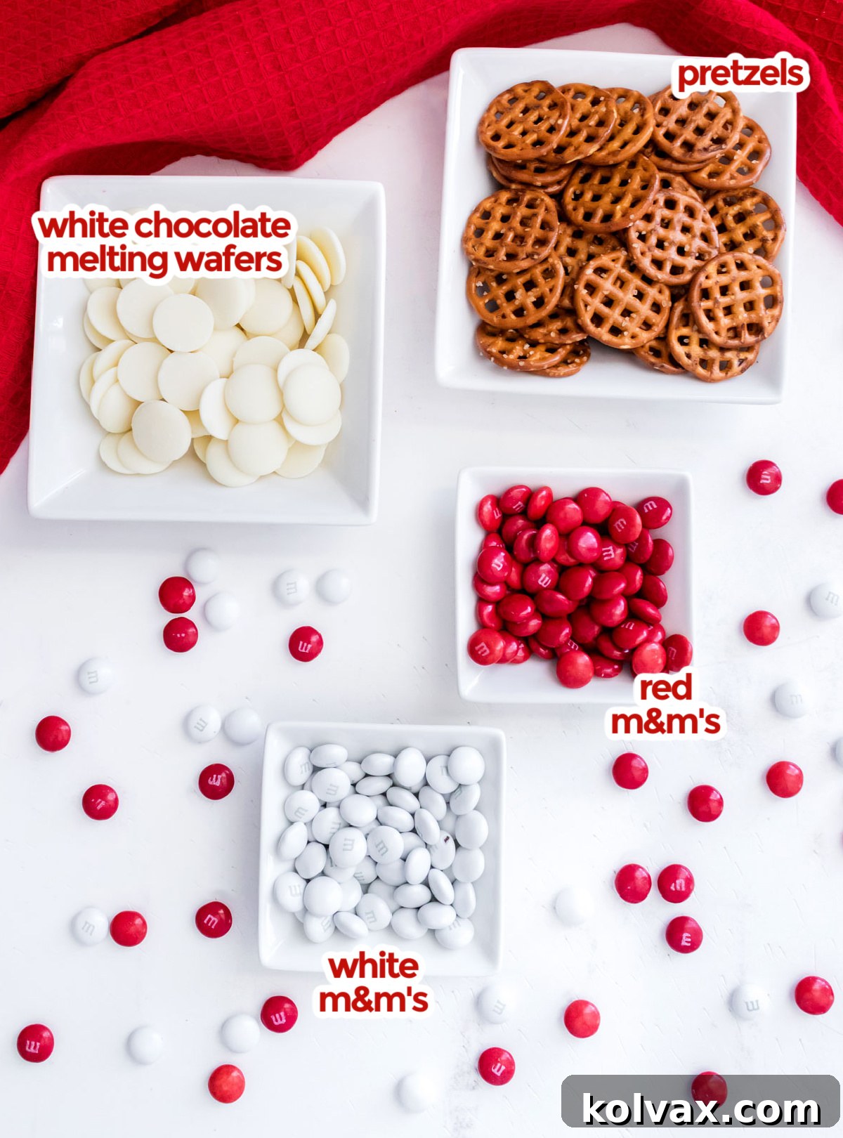 All the ingredients you will need to make Holiday Poinsettia Pretzel Bites including pretzels, candy melts and M&M's.