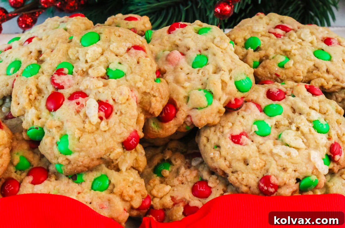 Closeup on a serving platter filled with Christmas M&M Rice Krispie Cookies sitting in front of Christmas decorations.