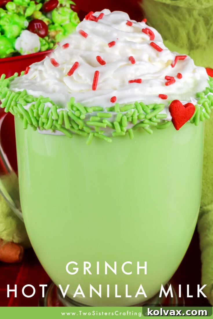 Grinch Hot Vanilla Milk with whipped cream and red sprinkles, a festive Christmas drink perfect for sharing on Pinterest.