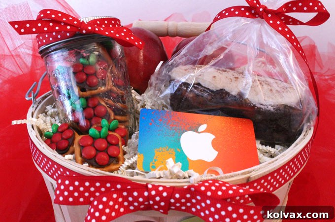 Create the ultimate DIY Teacher Appreciation Gift Basket featuring delicious apple themed treats like Apple Pretzel Bites, Mini Apple Bread, and a practical Apple iTunes Gift Card. A thoughtful and easy-to-make gift your child's teacher will cherish.