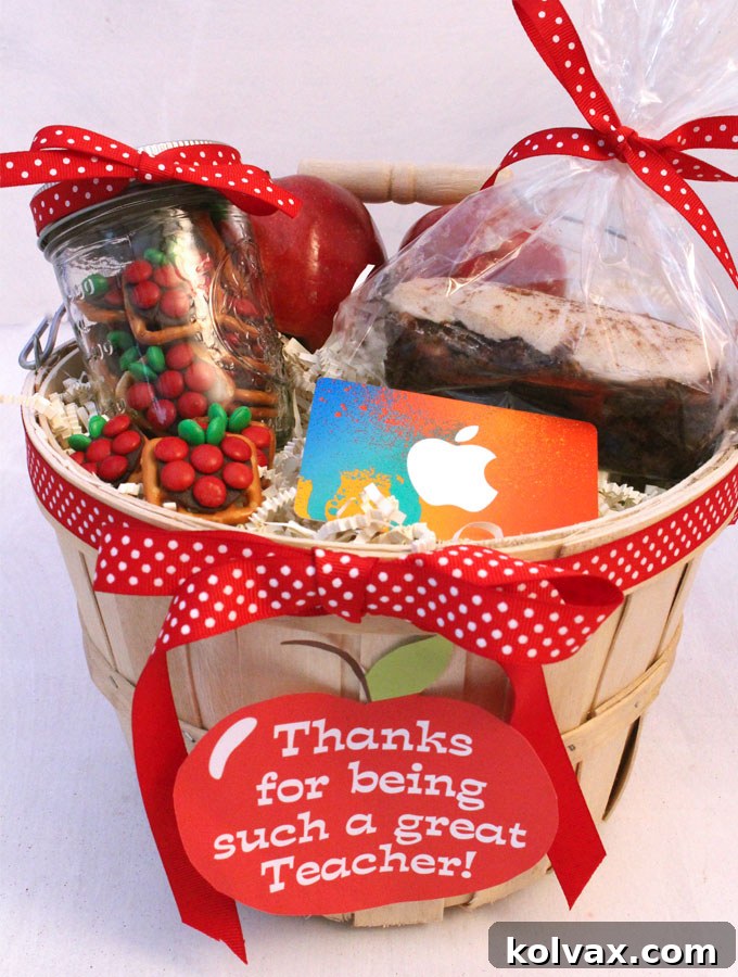 A beautifully assembled DIY Teacher Appreciation Gift Basket filled with apple themed delights and an iTunes gift card.