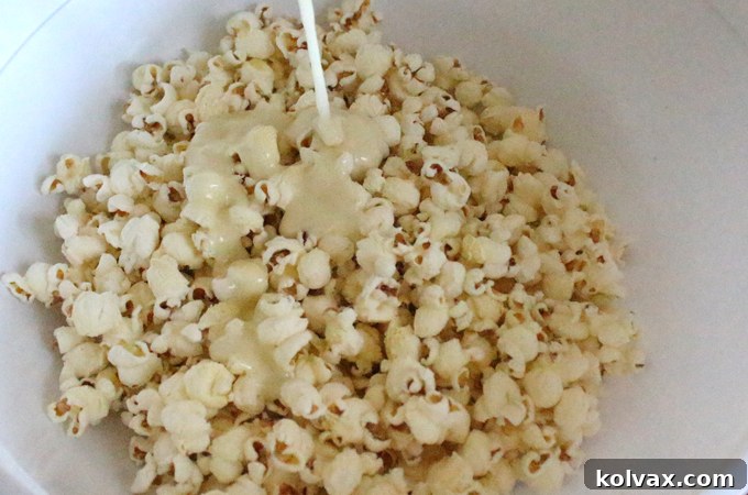 Drizzling warm marshmallow mixture over salted popcorn