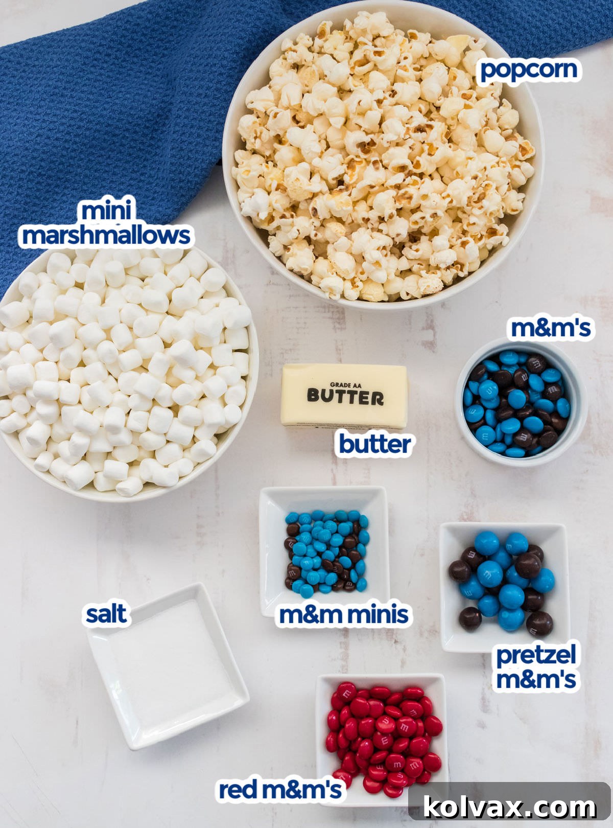 All the essential ingredients for making Star Wars Popcorn laid out: Mini Marshmallows, freshly popped Popcorn, a variety of M&M's, Butter, and Salt. Simple and delicious!
