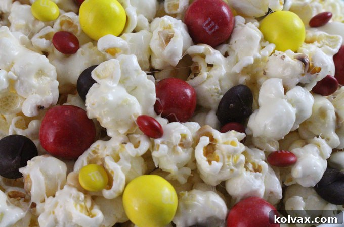 Kansas City Chiefs Popcorn generously topped with red, yellow, and chocolate candies.