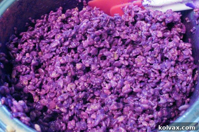 Purple Rice Krispie Treats mixture, with cereal fully coated in the vibrant marshmallow blend, ready for shaping into jerseys.