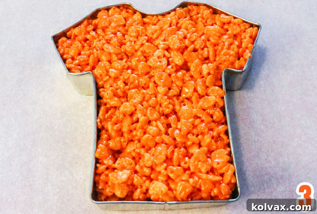 Orange Rice Krispie Treat mixture pressed into a T-Shirt Cookie Cutter.