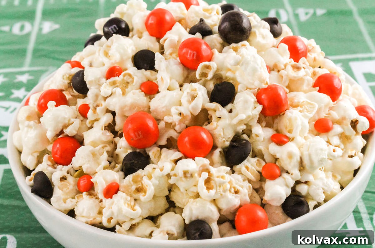Who Dey Popcorn 2 Close-up of a white serving bowl brimming with festive Cincinnati Bengals Popcorn, resting on a football field-themed tablecloth, ready for game day.