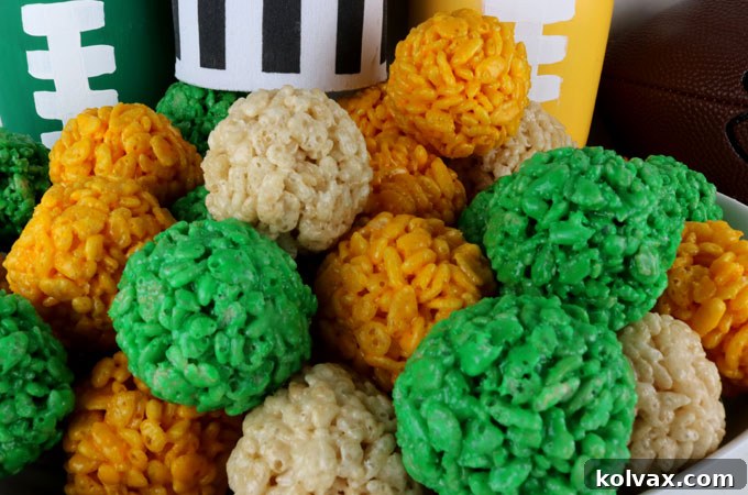 Bite-sized Green Bay Packers Rice Krispie treats shaped into balls, coated in green and gold.