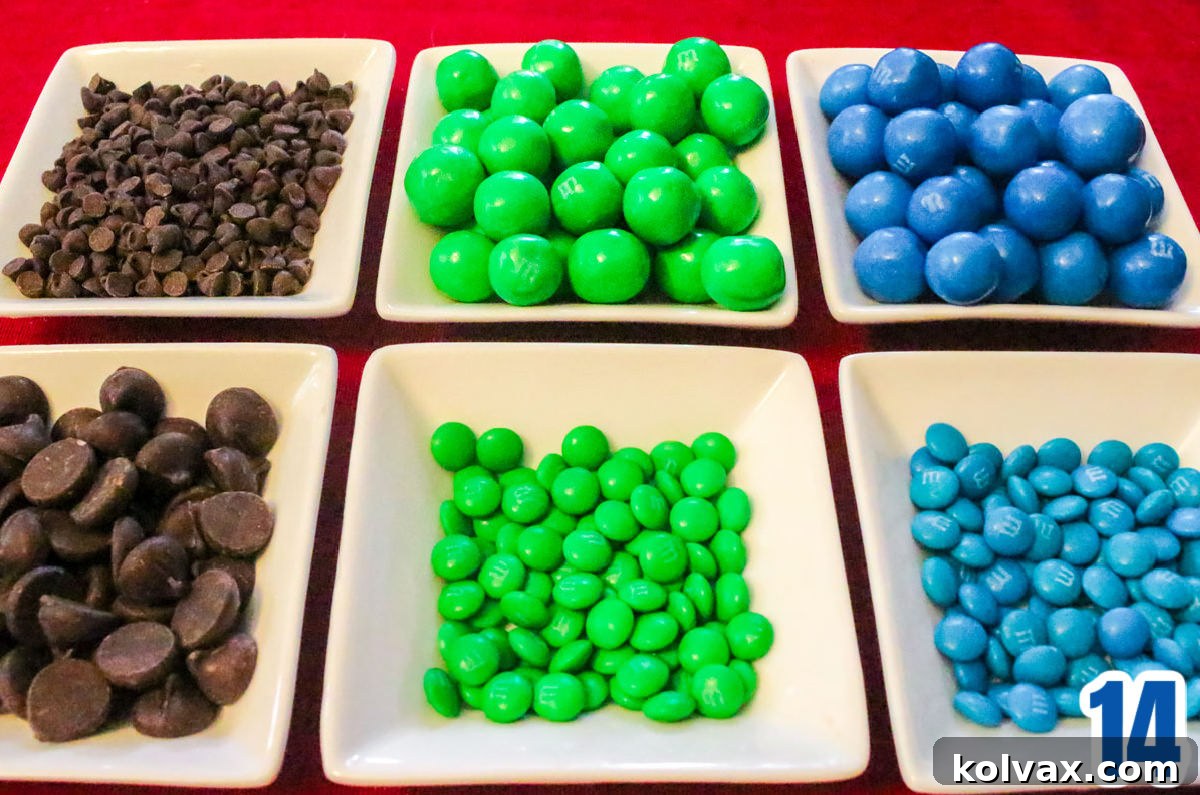 A photo of six white ramekins filled with a vibrant assortment of blue and green M&M's and rich chocolate chips, ready to be added to the popcorn.