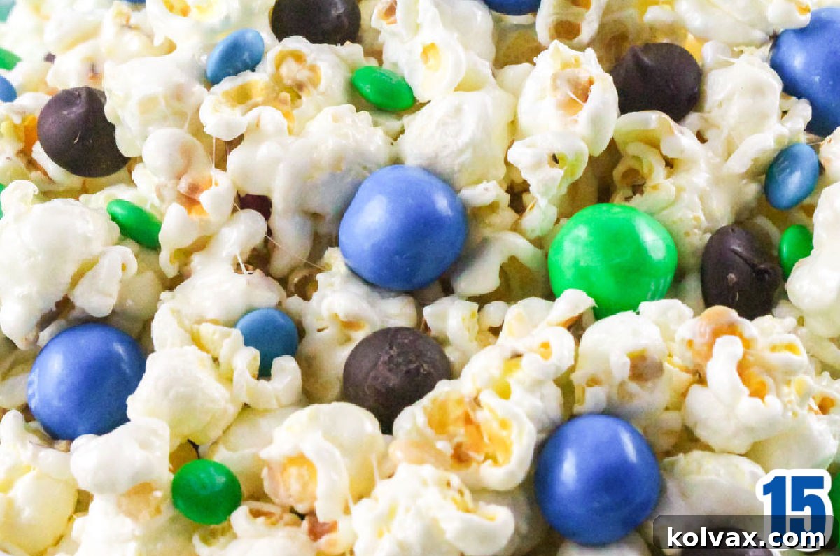 A close-up shot of a bowl of Seattle Seahawks Popcorn, showcasing the generous addition of blue and green candies mixed throughout the sweet and salty popcorn.