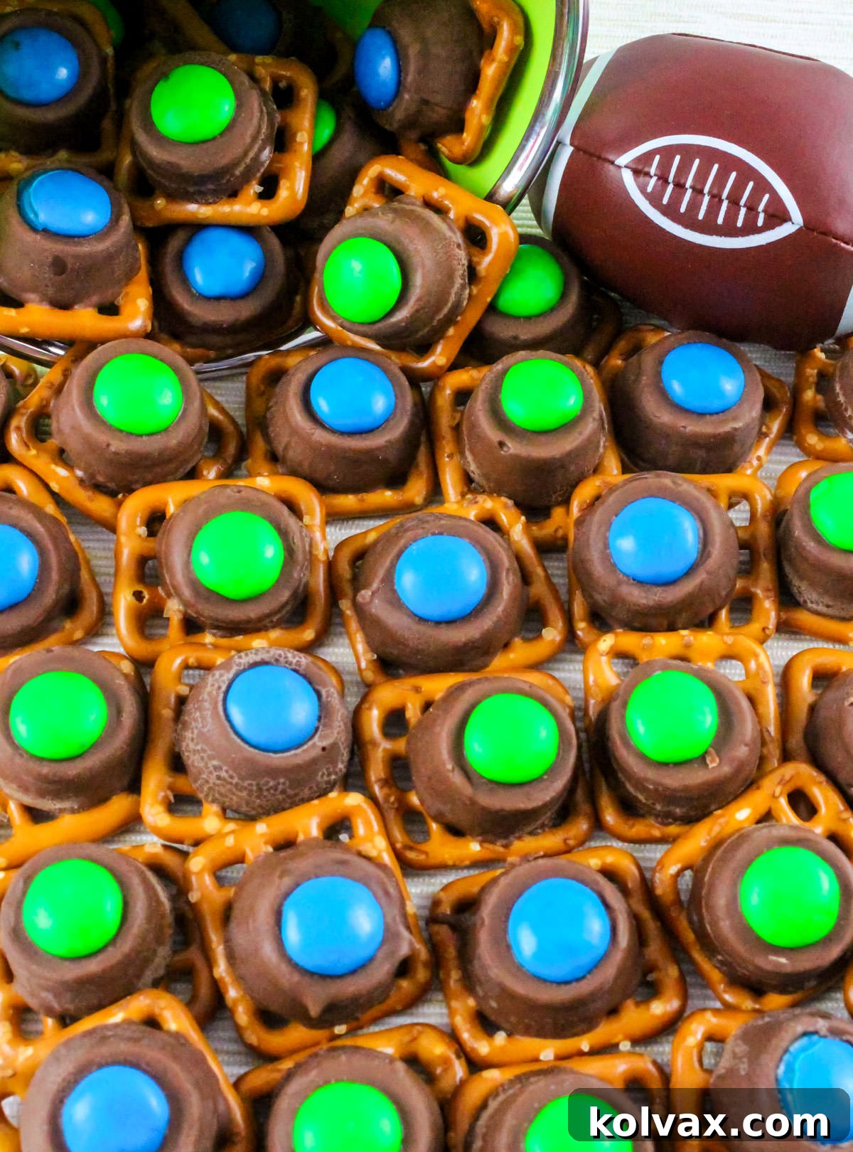 A batch of Seattle Seahawks Pretzel Bites tumbling out of a mason jar on a white table.