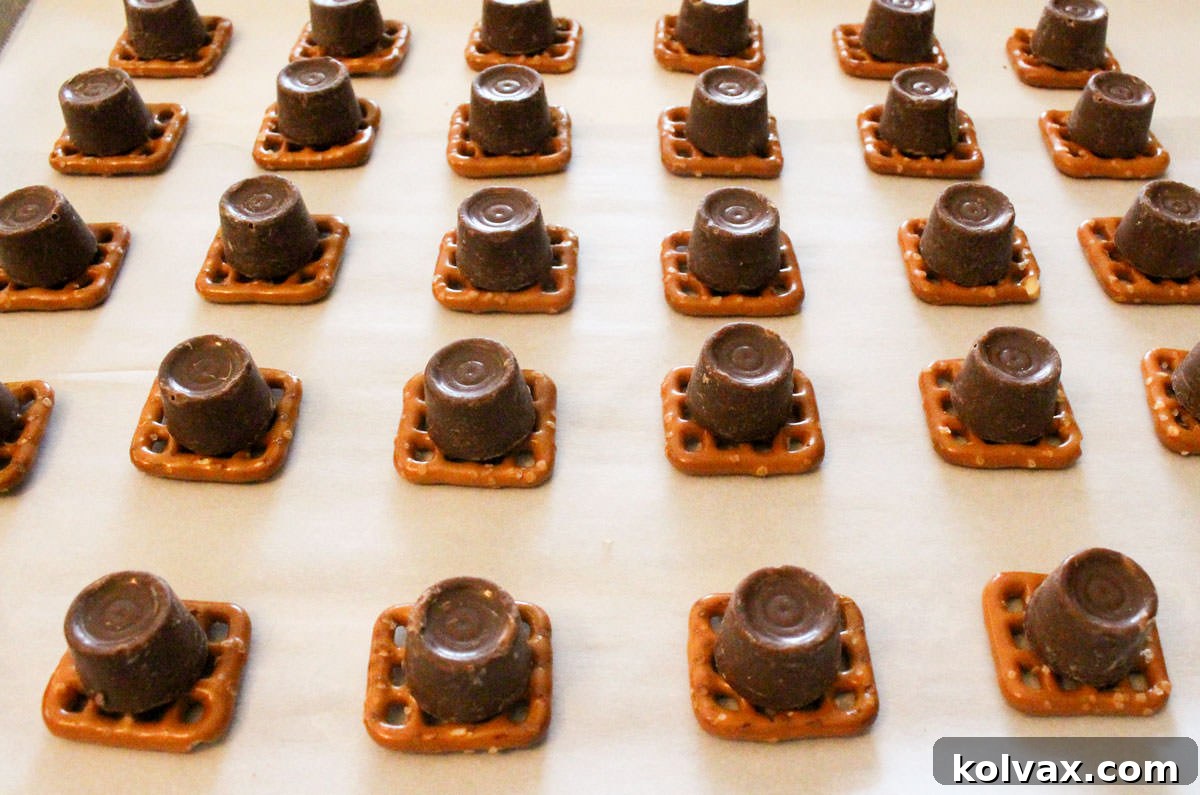 Patriots Game Day Pretzel Bites 4 Cookie sheet filled with rows of Pretzels topped with Rolo Candies.