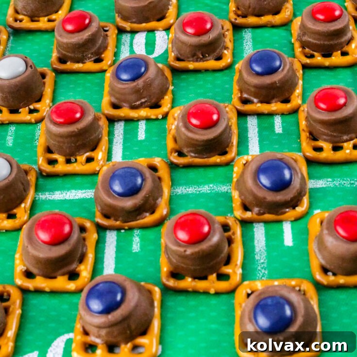 Patriots Game Day Pretzel Bites 7 A batch of New England Patriots Pretzel Bites lined up in rows on a green football tablecloth.