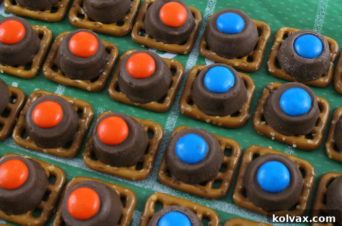 Close-up shot of vibrant Denver Broncos Pretzel Bites, featuring orange and blue M&Ms on melted Rollos and pretzels