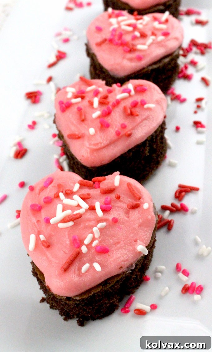 Close-up view of heart-shaped Valentine's Cake Bites on a plate, ready to serve.