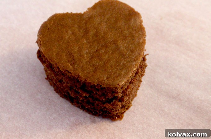 Pile of freshly cut chocolate heart cake bites, ready for frosting.