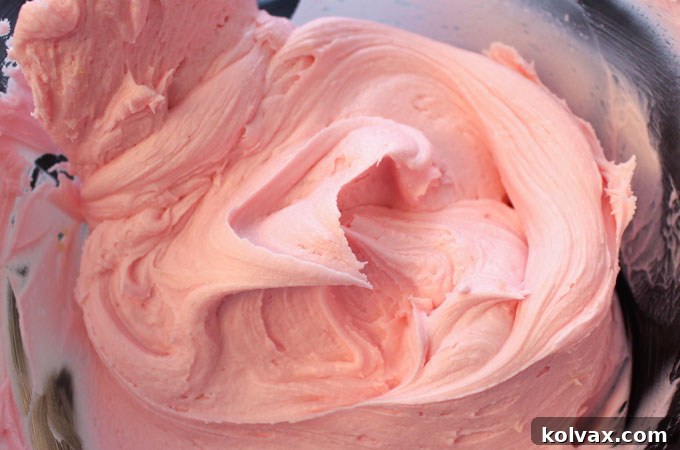 Creamy pink buttercream frosting, ideal for Valentine's Day desserts.