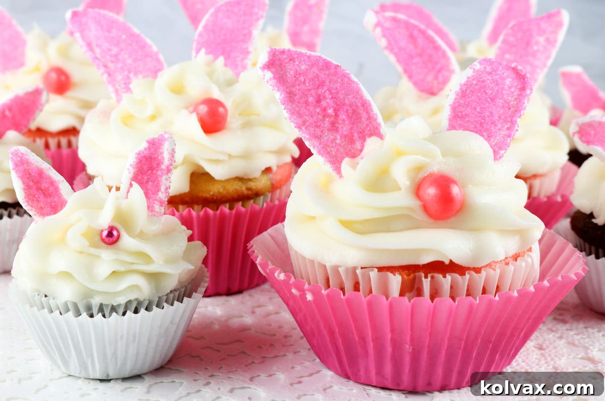 Close up of a regular sized Bunny Cupcake and a Mini Bunny Cupcake sitting on a white surface, showing the difference in scale.