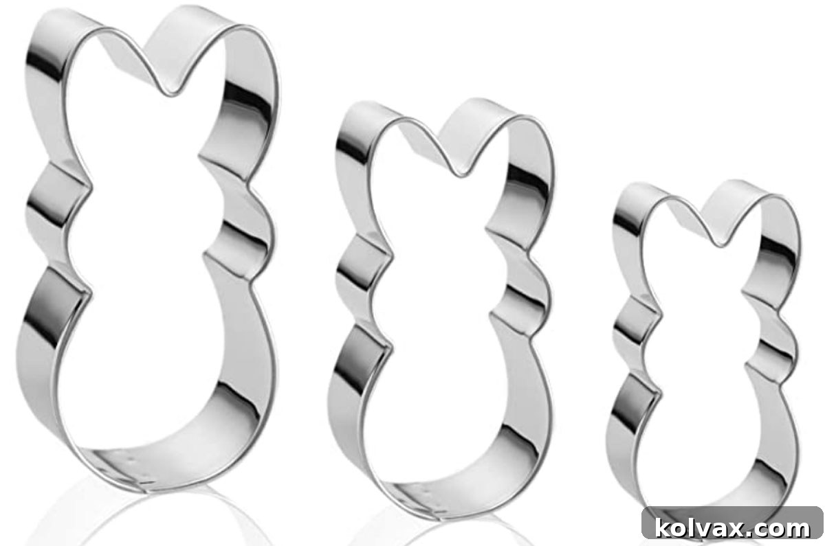 A close-up photograph showcasing a matching set of three Peeps Easter Bunny cookie cutters, varying slightly in size, laid out on a clean surface.