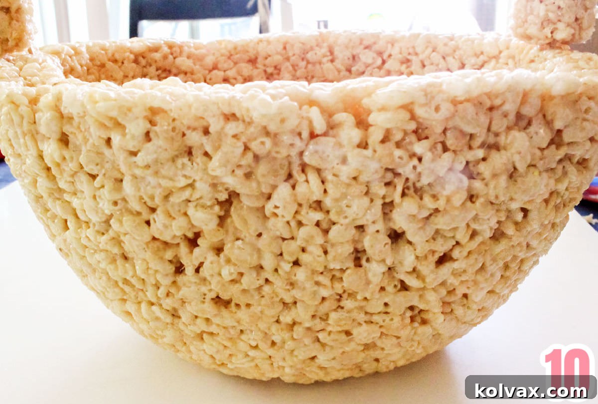A close-up view illustrating how to securely attach the Rice Krispie Treat handle to the basket's base using toothpicks, demonstrating a simple yet effective joining method.