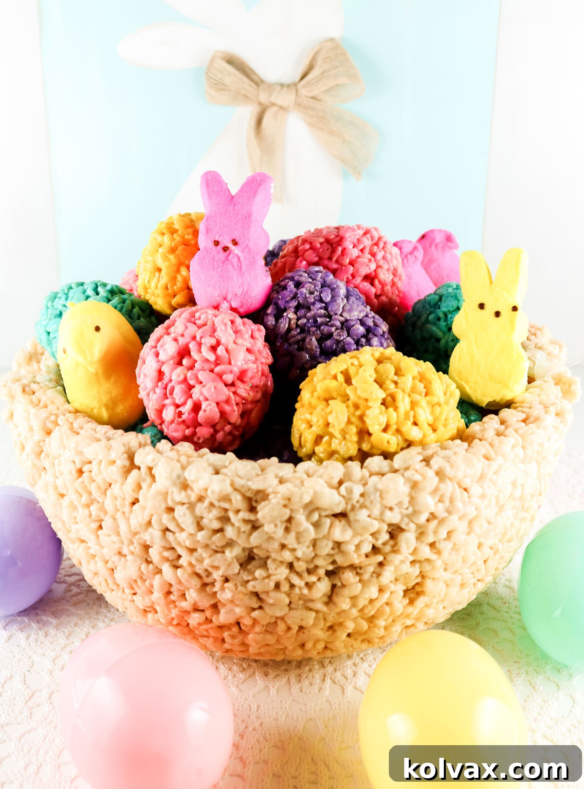 A beautiful close-up of the completed Rice Krispie Treat Easter Basket Centerpiece, brimming with an assortment of brightly colored Rice Krispie Treat Eggs, ready to adorn an Easter table.