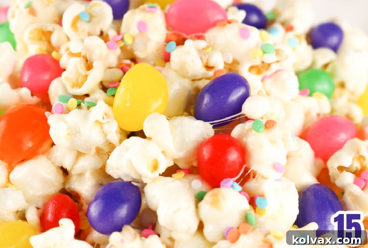 A close-up shot of a freshly prepared batch of Jelly Bean Popcorn, meticulously showcasing the details of the glistening marshmallow-coated popcorn interspersed with an abundance of colorful jelly beans and delicate pastel sprinkles, all ready for enjoyment.